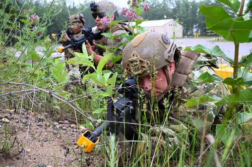 Tech. Sgt. Jared Bull, 433rd Contingency Response Flight specialist, right, and Staff Sgt. Marco Briebeiscas, center, 433rd CRF specialist, execute battle drills at the Contingency Location Operations Rehearsal (CLOR 24) at Alpena, Michigan June 25, 2024.