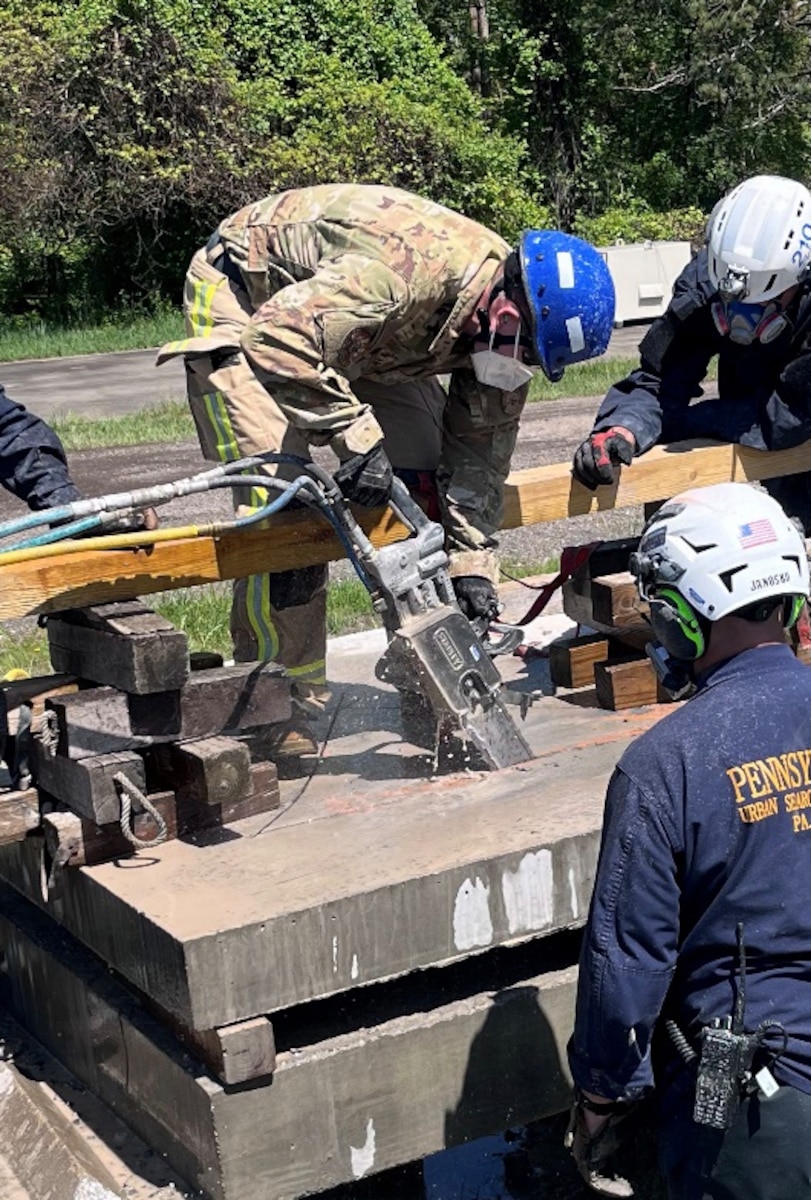 Master Sgt. John Kovacic with the 171st Air Refueling Wing Fire and Emergency Services Flight operates the DS11 hydraulic concrete chainsaw
