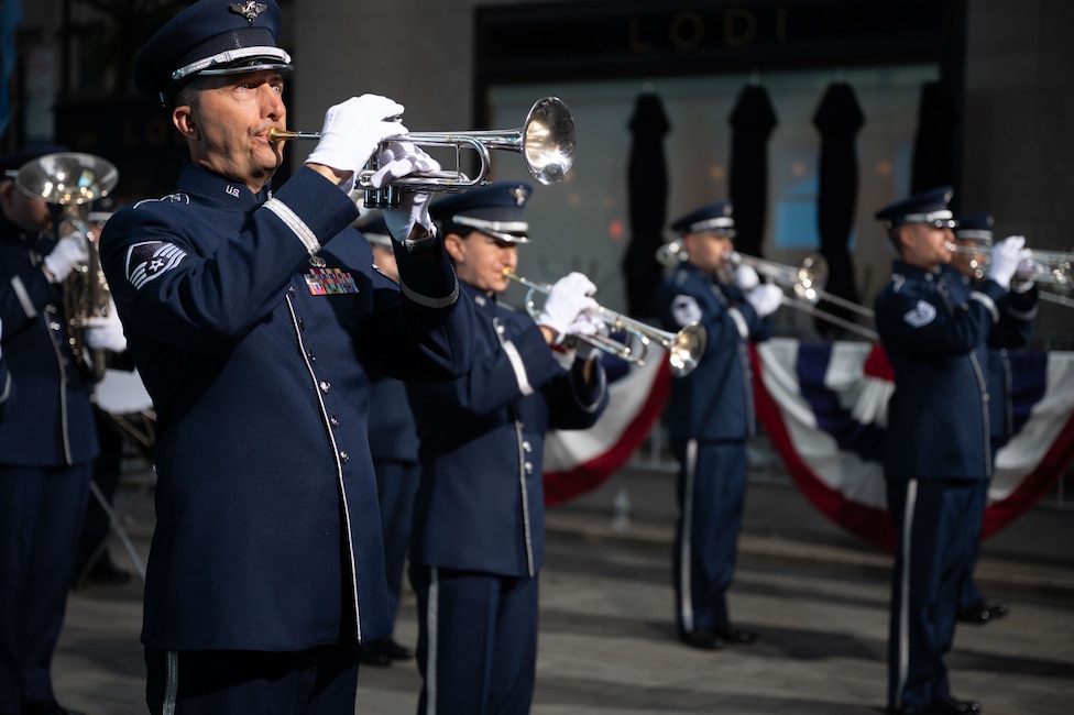 military band members playing brass instruments on public plaza