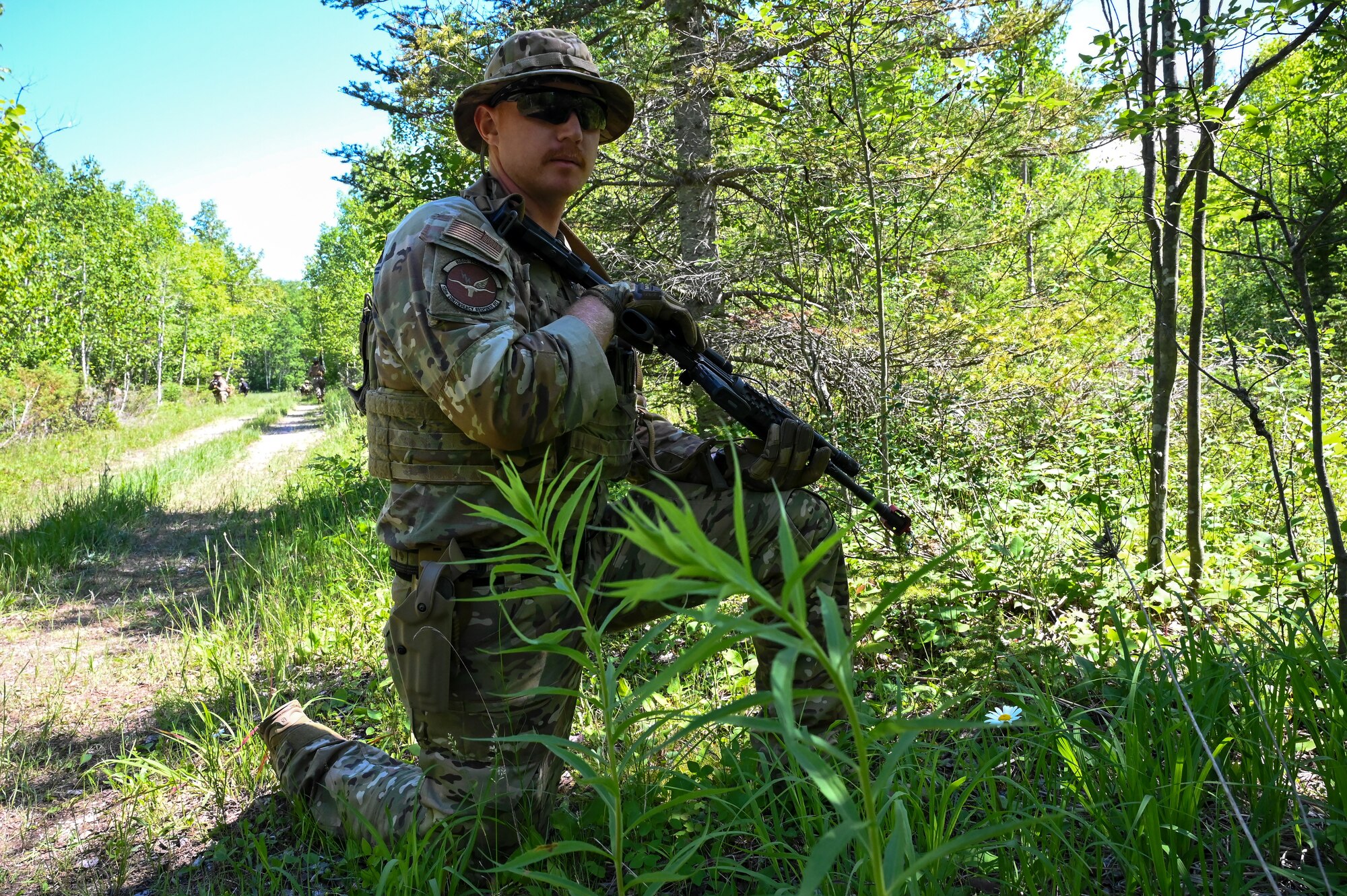 Staff Sgt. Joseph Hunn, 136th Contingency Response Flight security forces second in command, trained team members from the 433rd Contingency Response Flight on advanced field training scenarios that implemented blank ammunitions, smoke grenade procedures, casualty evacuation, beach assaults, and opposing force tactics at the Contingency Location Operations Rehearsal (CLOR 24) in Alpena, Michigan June 27, 2024.