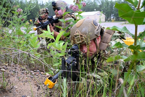 Tech. Sgt. Jared Bull, 433rd Contingency Response Flight specialist, right, and Staff Sgt. Marco Briebeiscas, center, 433rd CRF specialist, execute battle drills at the Contingency Location Operations Rehearsal (CLOR 24) at Alpena, Michigan June 25, 2024.