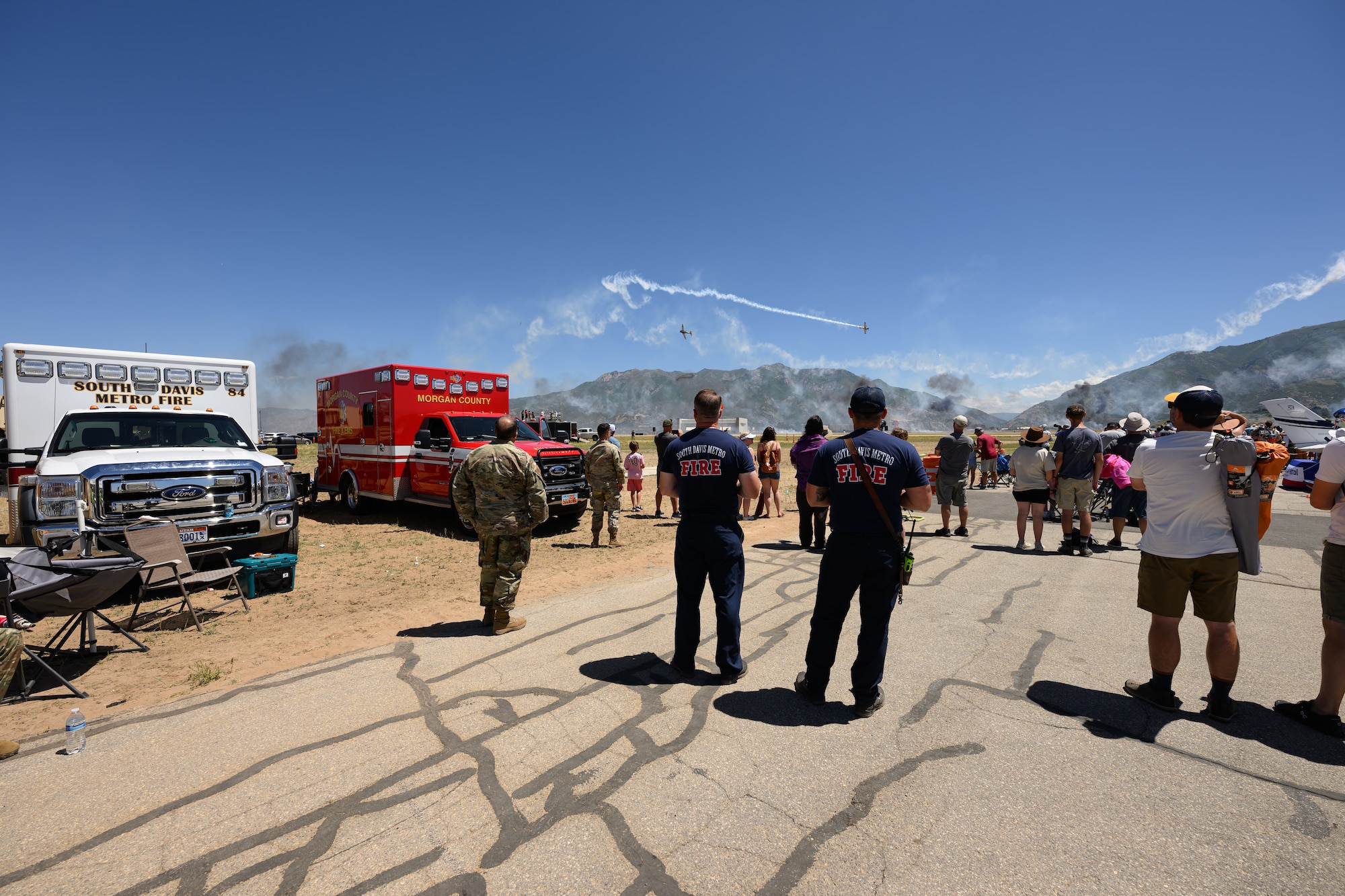 Members of the South Davis Metro Fire Department watch planes in the sky.