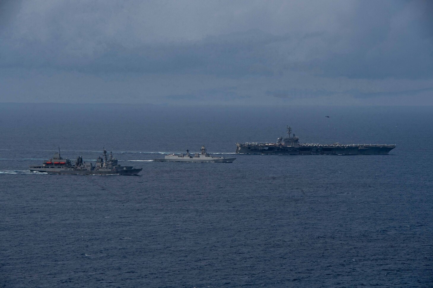 From front to back: The Arleigh Burke-class guided-missile destroyer USS Daniel Inouye (DDG 118), the Indian Navy Aditya-class replenishment and repair ship INS Aditya (A59), the Indian Navy Visakhapatnam-class stealth guided-missile destroyer INS Visakhapatnam (D66), and the Nimitz-class aircraft carrier USS Theodore Roosevelt (CVN 71) sail together in the Indian Ocean during a joint maritime activity, July 12, 2024.