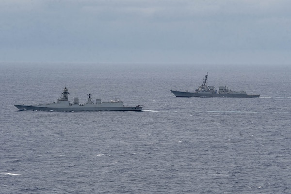 The Indian Navy Visakhapatnam-class stealth guided-missile destroyer INS Visakhapatnam (D66), left, and the Arleigh Burke-class guided-missile destroyer USS Daniel Inouye (DDG 118) sail together in the Indian Ocean during a joint maritime activity, July 12, 2024.