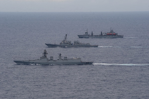 The Indian Navy Visakhapatnam-class stealth guided-missile destroyer INS Visakhapatnam (D66), front, the Arleigh Burke-class guided-missile destroyer USS Daniel Inouye (DDG 118), middle, and the Indian Navy Aditya-class replenishment and repair ship INS Aditya (A59) sail together in the Indian Ocean during a joint maritime activity, July 12, 2024.