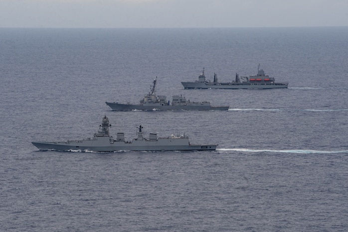 The Indian Navy Visakhapatnam-class stealth guided-missile destroyer INS Visakhapatnam (D66), front, the Arleigh Burke-class guided-missile destroyer USS Daniel Inouye (DDG 118), middle, and the Indian Navy Aditya-class replenishment and repair ship INS Aditya (A59) sail together in the Indian Ocean during a joint maritime activity, July 12, 2024.