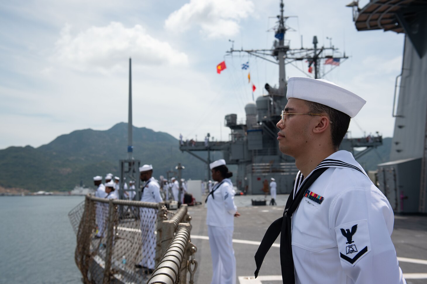 CAM RANH INTERNATIONAL PORT, Vietnam (July 8, 2024) – Culinary Specialist 3rd Class Kannon Brownlow, from Decatur, Indiana, mans the rails aboard U.S. 7th Fleet flagship USS Blue Ridge (LCC 19) while mooring in Cam Ranh, Vietnam, July 8, 2024. As the 7th Fleet flagship, Blue Ridge is the oldest operational ship in the Navy and routinely operates with allies and partners in preserving a free and open Indo-Pacific. (U.S. Navy photo by Mass Communication Specialist Seaman Thomas Furnish)