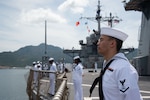 CAM RANH INTERNATIONAL PORT, Vietnam (July 8, 2024) – Culinary Specialist 3rd Class Kannon Brownlow, from Decatur, Indiana, mans the rails aboard U.S. 7th Fleet flagship USS Blue Ridge (LCC 19) while mooring in Cam Ranh, Vietnam, July 8, 2024. As the 7th Fleet flagship, Blue Ridge is the oldest operational ship in the Navy and routinely operates with allies and partners in preserving a free and open Indo-Pacific. (U.S. Navy photo by Mass Communication Specialist Seaman Thomas Furnish)