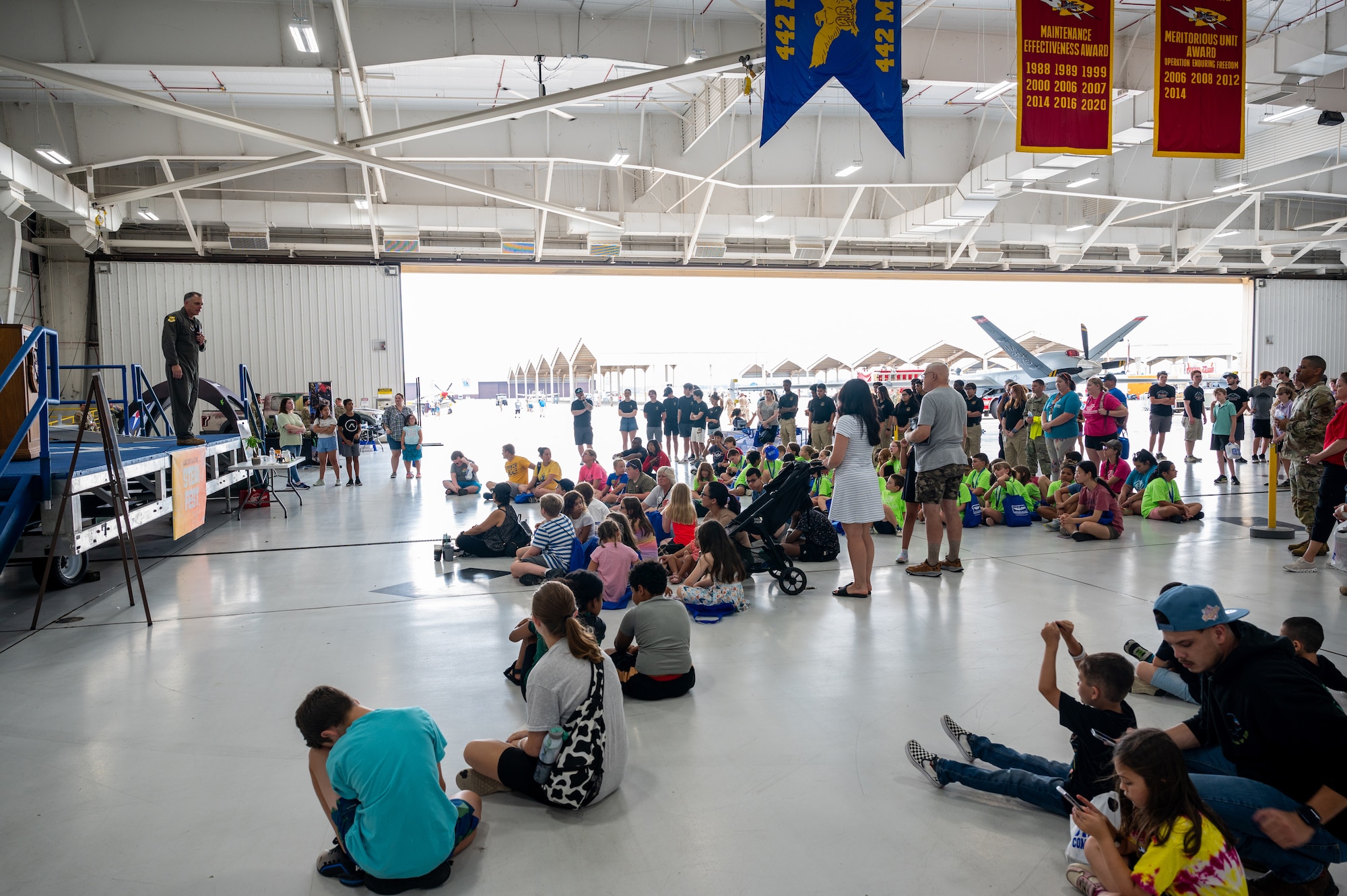 U.S. Air Force Col. Keith Butler, 509th Bomb Wing commander, speaks at the 2024 Wings Over Whiteman STEM Fest at Whiteman Air Force Base, Mo., July 12, 2024. STEM Fest was open to the public and provided children and their parents the ability to see various presentations throughout the day and opportunities to engage with various science, technology, engineering and mathematics organizations similar to a career fair. (U.S. Air Force photo by Airman 1st Class Bryce Moore)