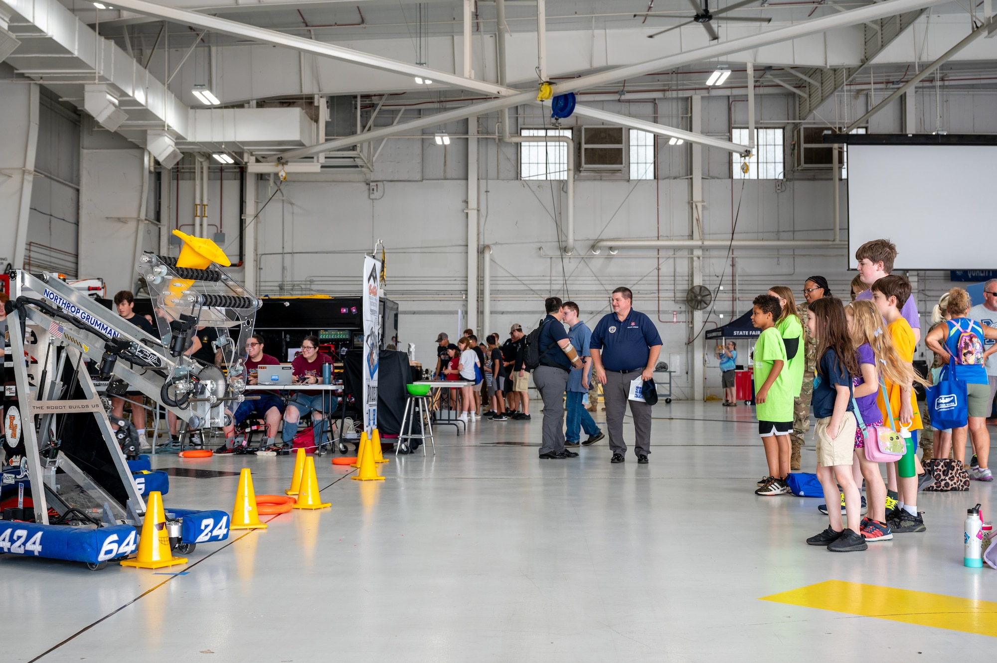 Local elementary school students look at exhibits during the 2024 Wings Over Whiteman STEM Fest at Whiteman Air Force Base, Mo., July 12, 2024. STEM Fest was open to the public and provided children and their parents the ability to see various presentations throughout the day and opportunities to engage with various science, technology, engineering and mathematics organizations similar to a career fair. (U.S. Air Force photo by Airman 1st Class Bryce Moore)