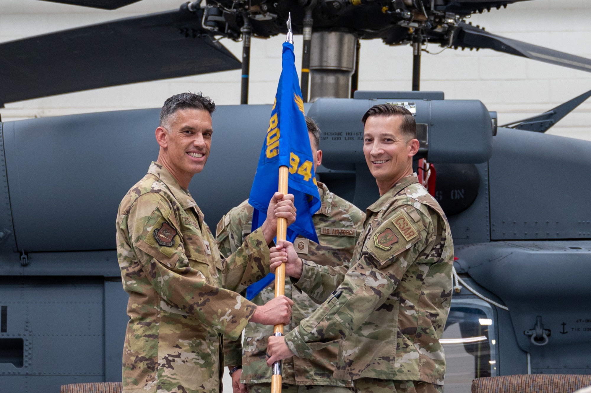 Col. Christopher Escajeda, 943d Rescue Group commander, presents the 943d Maintenance Squadron guidon to Maj. Eric Hinkley.