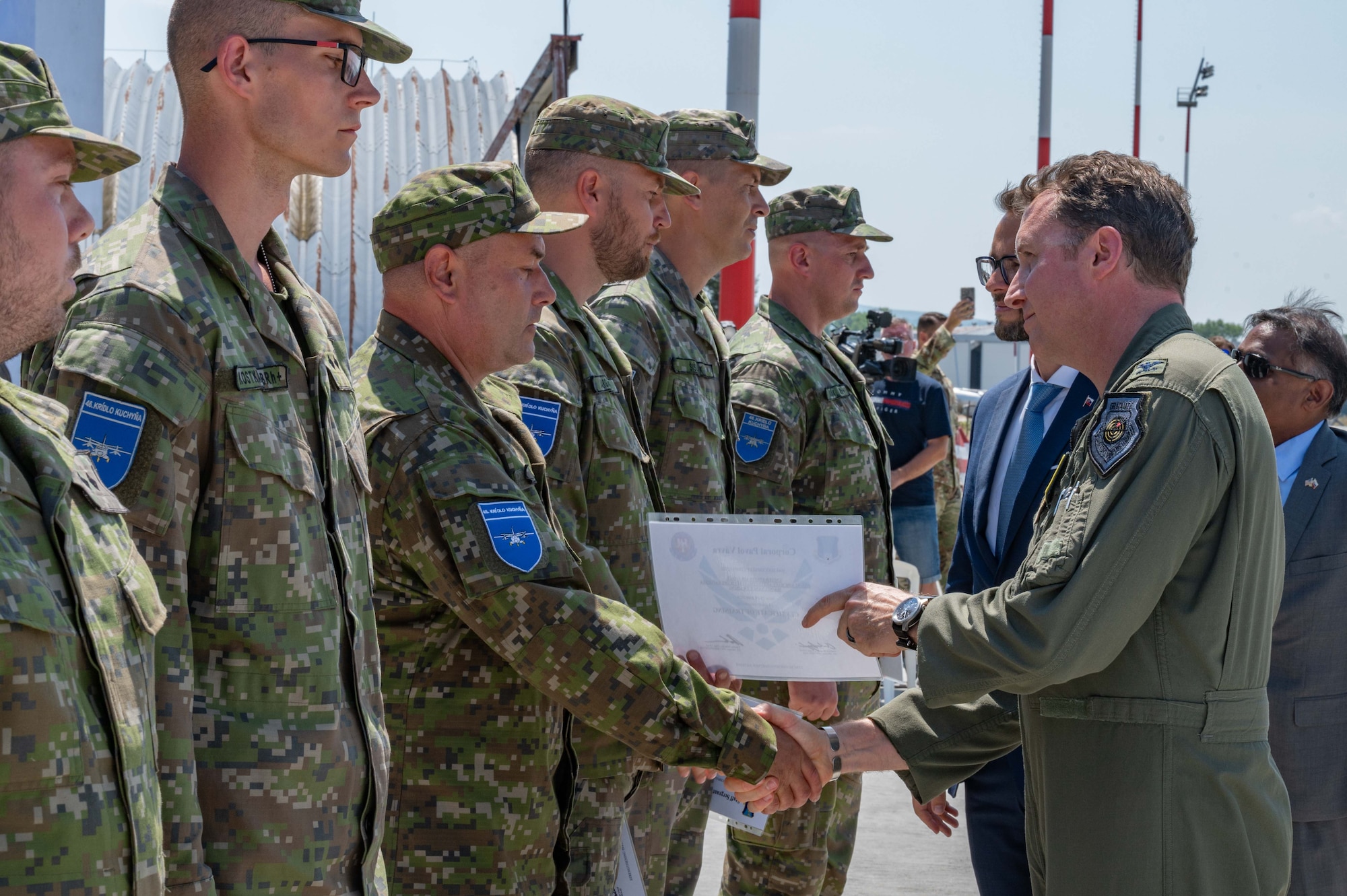 Col. Matthew Bartlett presents a certificate of training to Slovak Air Force members