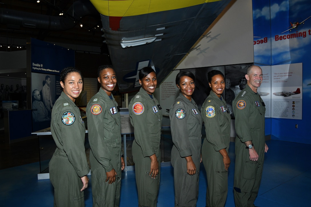 Vice Commandant of the Coast Guard Adm. Charles Ray awards Lt. Ronaqua “Ronnie” Russel, assigned to Coast Guard Air Station Miami, the Air Medal, at an event in Tuskegee, Alabama, Feb. 21, 2019.