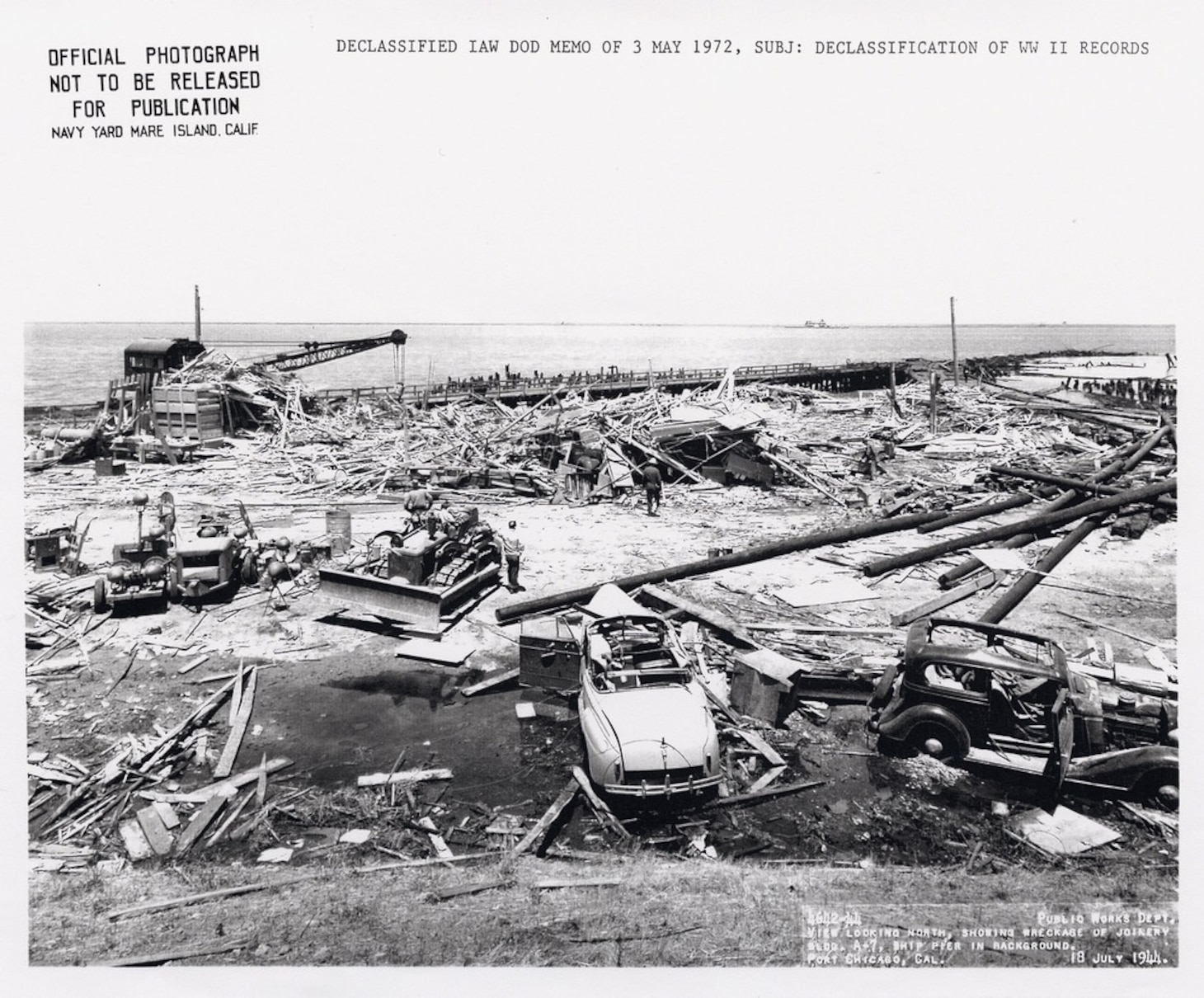 View looking north, showing wreckage of Joinery Building A-7. Ship pier in background, ca. 18 July 1944. Image courtesy National Park Service.