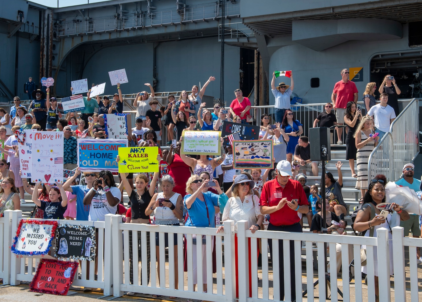 Family and friends prepare for the Nimitz-class aircraft carrier USS Dwight D. Eisenhower (CVN 69) to return to Naval Station Norfolk, July 14, 2024, concluding a nine-month deployment to the Atlantic.