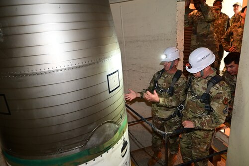 Chief Master Sgt. of the Air Force David Flosi points out aspects of an ICBM to Chief Master Sgt. Edwin Ludwigsen, command chief for Air Force Personnel Command, during a visit to the Alfa-06 launch facility near Pine Bluffs, Wyoming, July 2, 2024. Flosi visited the 90th Missile Wing at F.E. Warren Air Force Base, Wyoming, and the missile field to witness how Airmen continue to provide 24/7 strategic deterrence, standing ready to respond at a moment’s notice in support of the most responsive leg of the nuclear triad. (U.S. Air Force photo by Glenn S. Robertson)