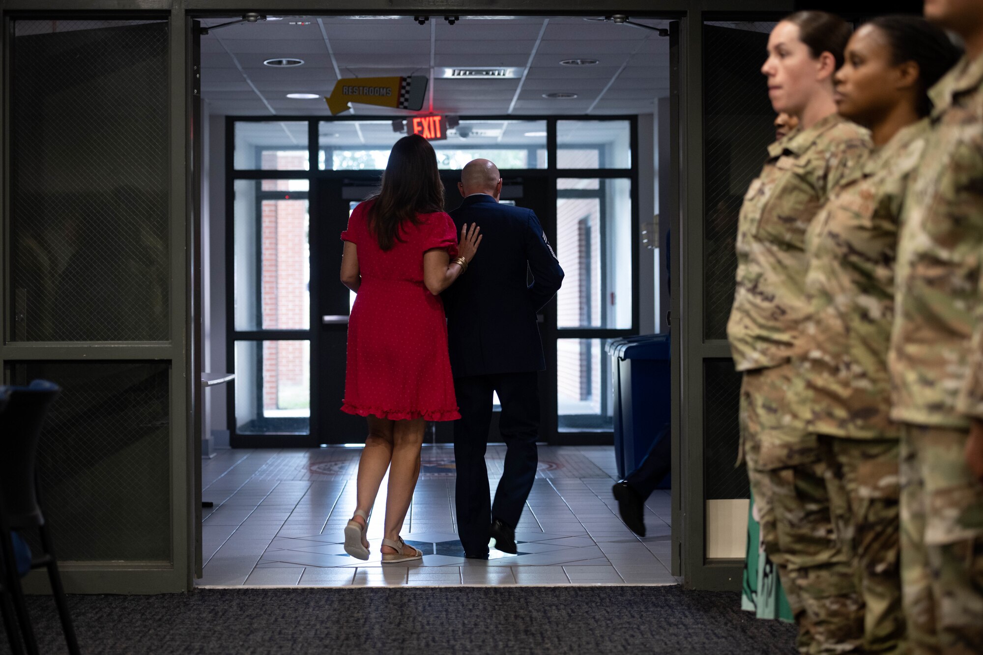 U.S. Airman and spouse depart building