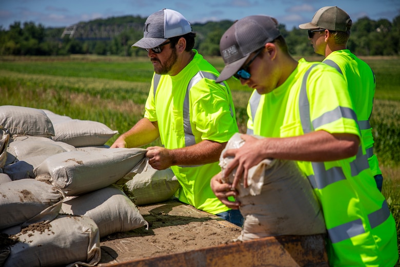 Corey Boyer, construction representative, U.S. Army Corps of Engineers Omaha District, oversees the placement of 2,800 sandbags along two levees in Atchison County and Holt County, Missouri, June 26, 2024. The sandbags were requested by local community levee sponsors to reinforce and temporarily raise levee heights in some of the lower laying areas as a precautionary measure against flood waters in June 2024 from the Missouri River. Nine USACE levee surveillance teams went onsite to levee locations and engaged with levee sponsors, state, tribal and emergency management officials to continue to monitor river conditions. (U.S. Army photo by Lisa Crawford)