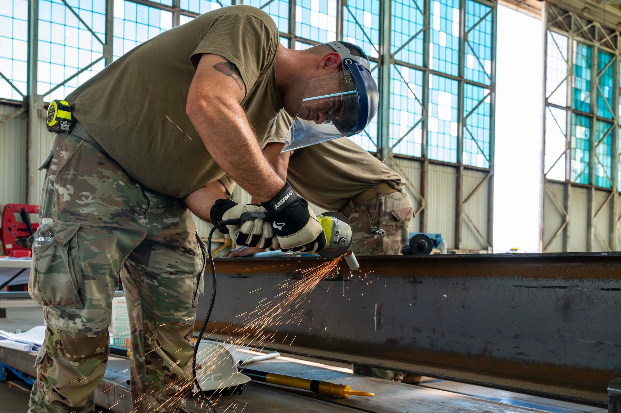 Two Airmen assigned to the 307th CES cut a pipe at Hangar 79 of the Pacific Aviation Museum on Ford Island