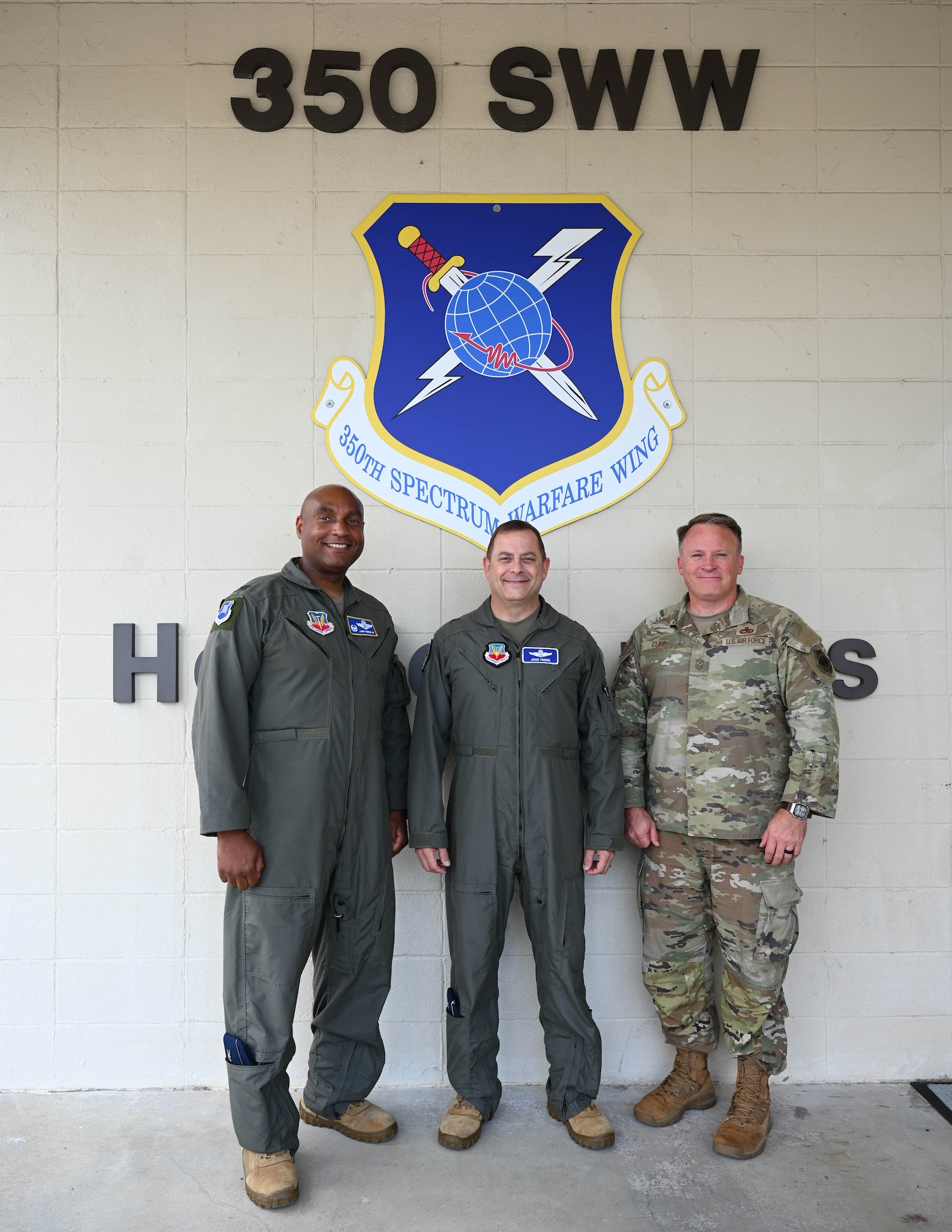 From the left: U.S. Air Force Col. Larry Fenner, Jr., 350th Spectrum Warfare Wing commander; U.S. Air Force Brig. Gen. Jesse Friedel, U.S. Air Force Warfare Center deputy commander; and U.S. Air Force Chief Master Sgt. Will Cupp, 350th SWW command chief, pose for a photo following Friedel’s 350th SWW immersion at Eglin Air Force Base, Florida, July 12, 2024. Friedel, fresh in the USAFWC deputy commander seat, visited multiple units during his visit to Florida to learn about their missions and contributions to the USAFWC and Combat Air Forces. (U.S. Air Force photo by Senior Airman Anna Smith)