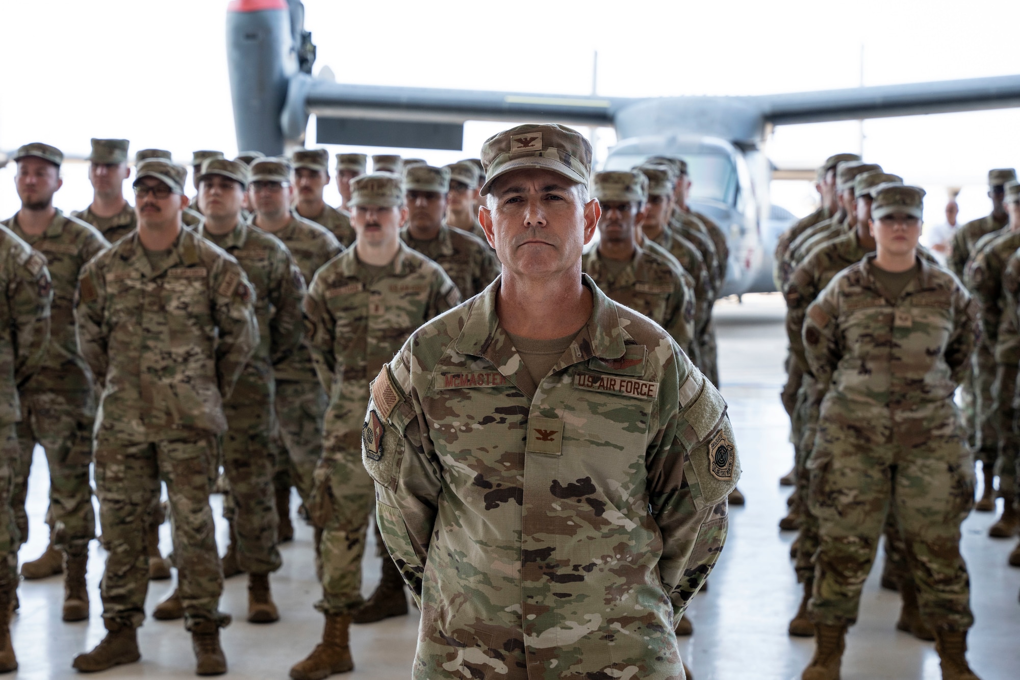 U.S. Air Force Col. Jeff McMaster, 27th Special Operations Wing deputy commander, and U.S. Air Force Airmen assigned to the 27 SOW, stand in formation during a change of command ceremony, Cannon Air Force Base, New Mexico, July 15, 2024. The 27 SOW’s mission is to develop, sustain, and employ professional Air Commandos who execute unconventional airpower and combat support to achieve the nation's security objectives.  (U.S. Air Force photo by Tech. Sgt. Kaylee Clark)