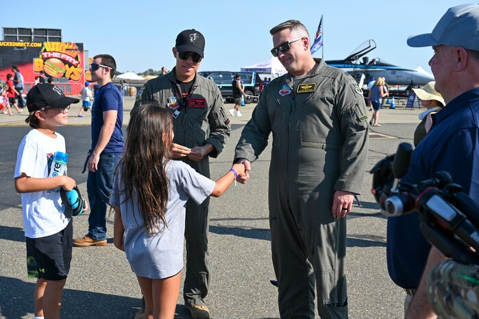 U.S. Air Force Col. James Bartran, 9th Reconnaissance Wing deputy commander, shakes hands with a young California Capital Airshow (CCA) attendee at the 18th annual CCA at Mather Airport, California, July 14, 2024.