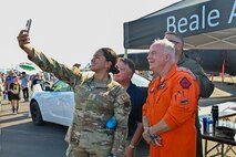 U.S. Air Force 2nd Lt. Sharon Cardenas, 9th Reconnaissance Wing public affairs officer, takes a selfie with members of Team Beale at the 18th annual California Capital Airshow (CCA) at Mather Airport, California, July 14, 2024.