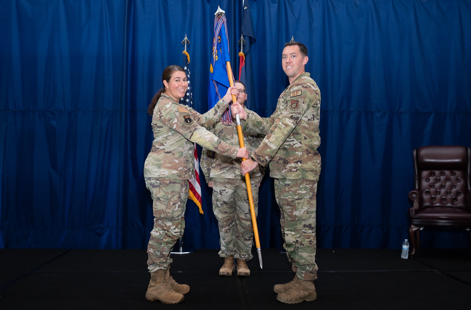 Col. Sheri Kraus, 36th Mission Support Group commander, presents the guidon to Maj. Kevin Brady, incoming 36th Security Forces Squadron commander, during an Assumption of Command Ceremony at Andersen Air Force Base, Guam, July 12, 2024. The 36th SFS is proud of their Arc Light Defender heritage. They are responsible to respond at a moment's notice to any situation that occurs on the Forward Edge. (U.S. Air Force photo by Staff Sgt. Pedro Tenorio)