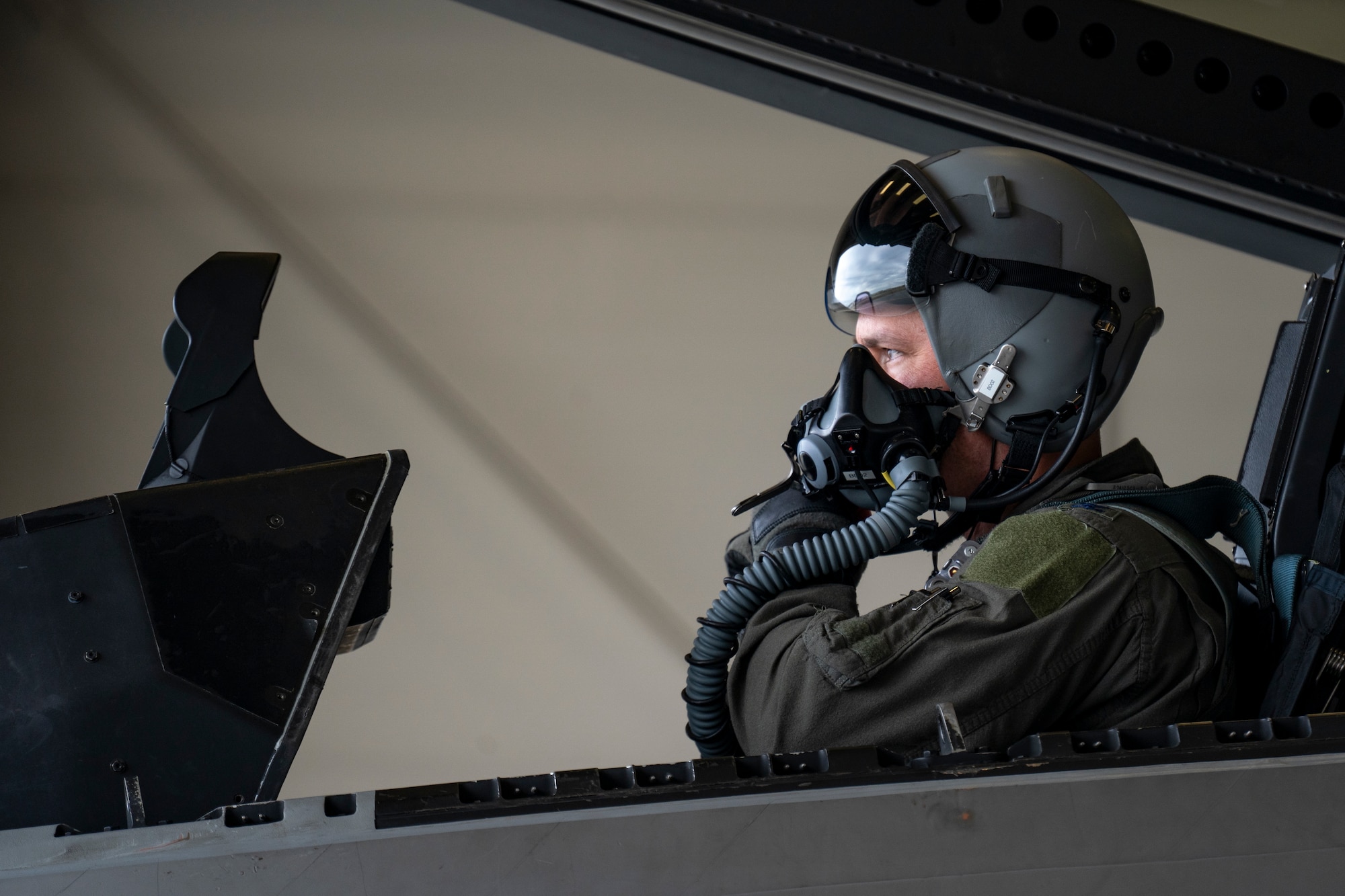 Pilot puts on helmet before takeoff.