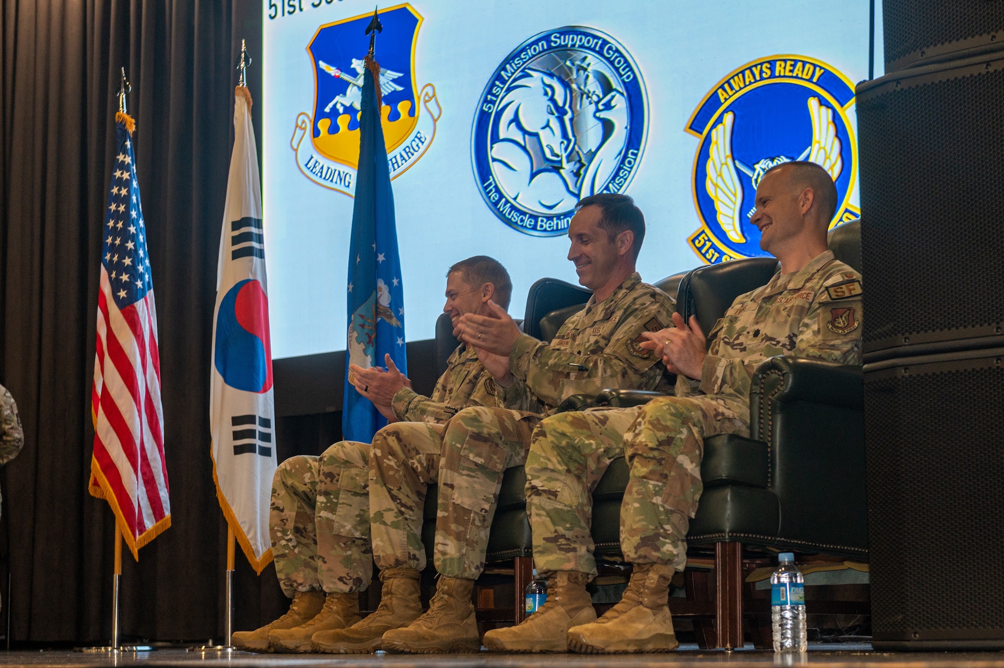 U.S. Air Force Col. Kyle Grygo, left, 51st Mission Support Group commander, Lt. Col. Nicholas Brence, middle, and Lt. Col. Daniel Evans, right, clap during opening remarks at the 51st Security Forces Change of Command Ceremony at Osan Air Base, Republic of Korea, June 12, 2024. Evans took command of the 51st SFS as Brence’s assignment at Osan ended. The 51st SFS Defenders train and integrate with host nation counterparts to remain ready to defend the base and guard the freedom of the 51 million people in the Republic of Korea. (U.S. Air Force photo by Senior Airman Kaitlin Frazier)