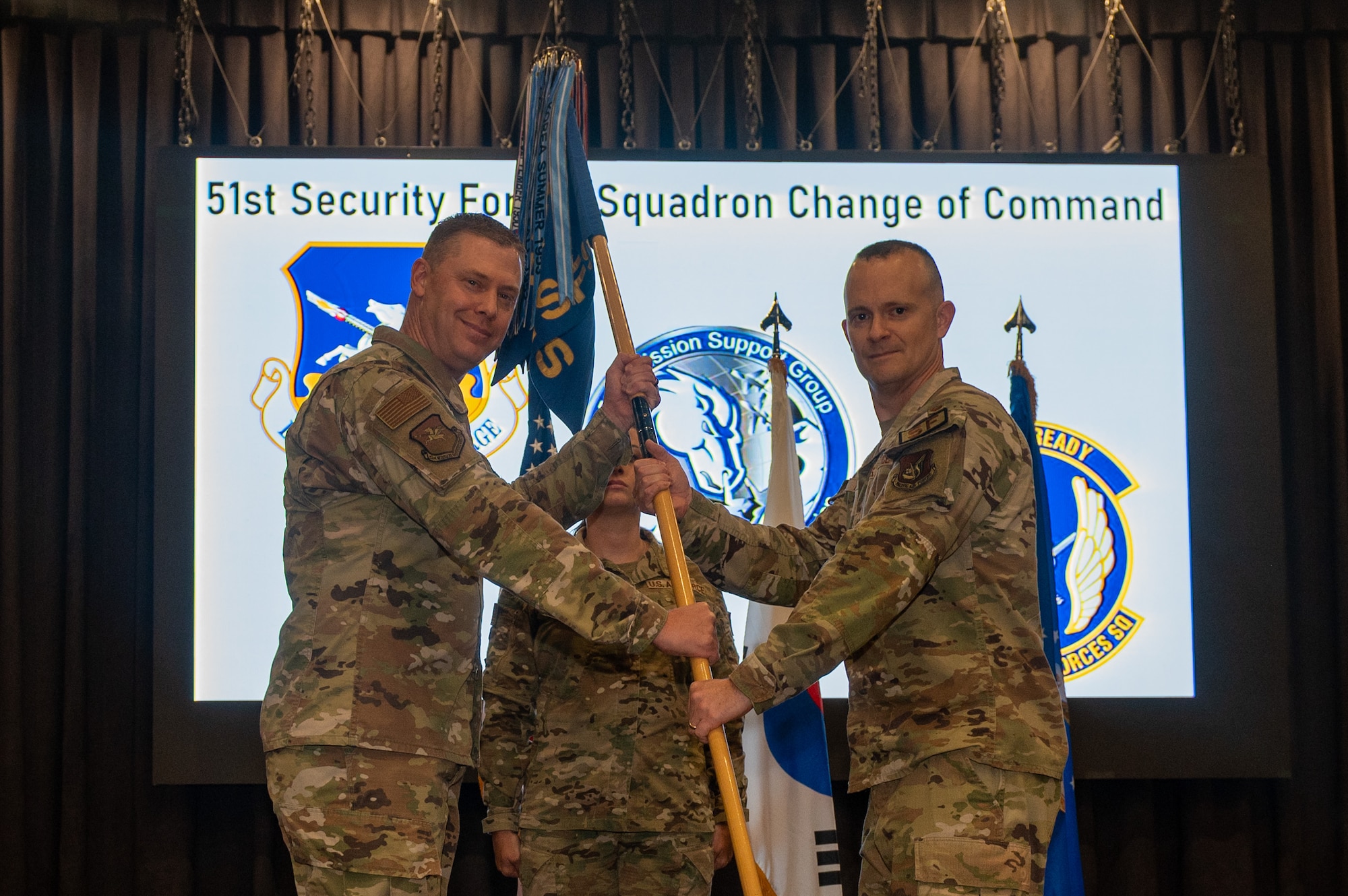 U.S. Air Force Lt. Col. Daniel Evans, right, accepts command of the 51st Security Forces Squadron from Col. Kyle Grygo, 51st Mission Support Group commander, during a change of command ceremony at Osan Air Base, Republic of Korea, June 12, 2024. Prior to taking command, Evans served as the commander of the 380th Expeditionary Security Forces Squadron at Al Dhafra Air Base, United Arab Emirates. (U.S. Air Force photo by Senior Airman Kaitlin Frazier)