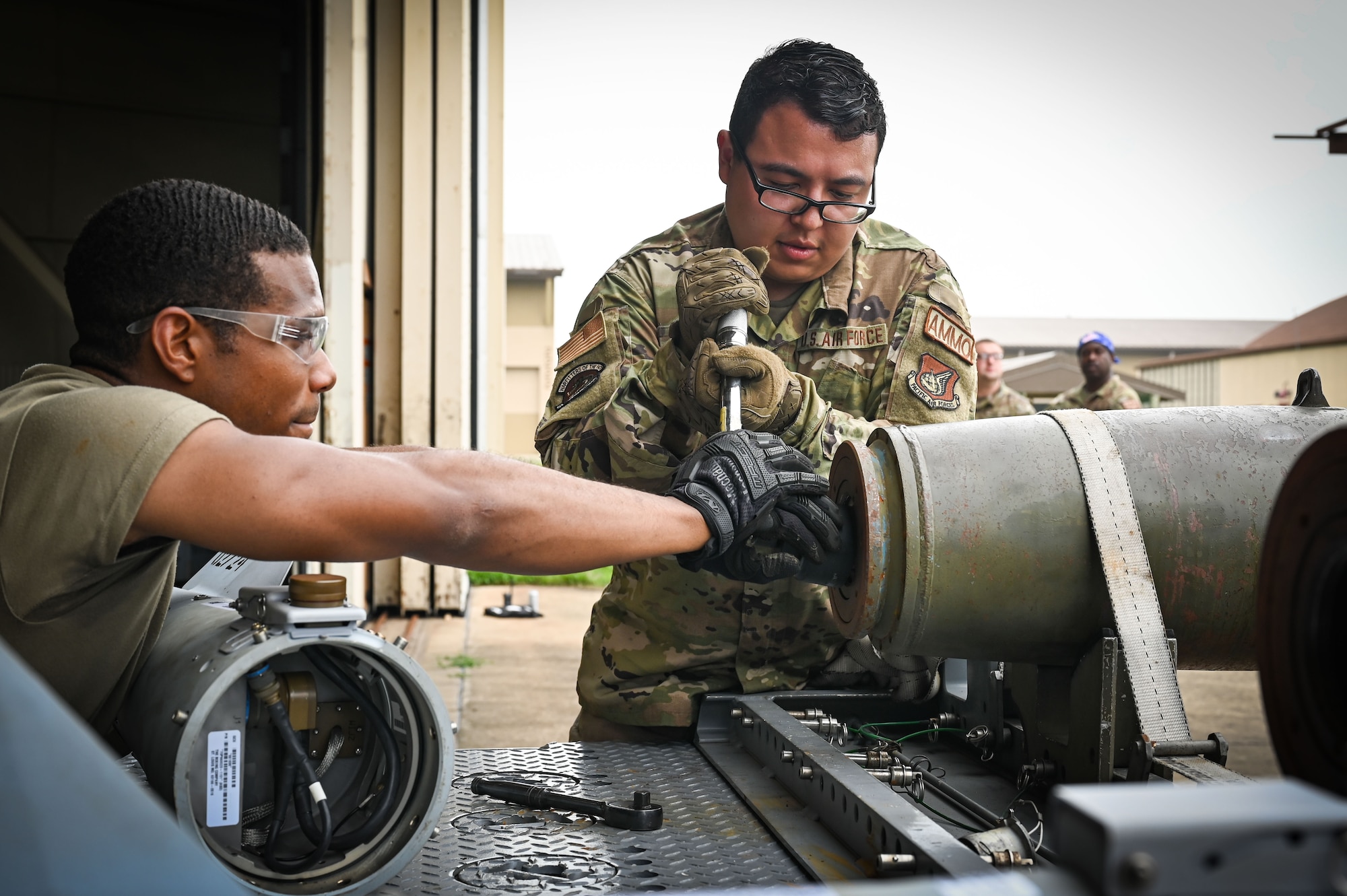 Senior Airman Marcus Mackey, left, and Staff Sgt. Eric Vaudt, 8th Maintenance Squadron conventional maintenance technicians, prepare munitions for loading during the 2024 2nd Quarter Dedicated Crew Chief and Load Crew Competition.
