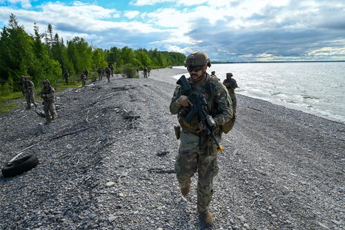 A 433rd Contingency Response Team lead by Technical Sgt. Jerome Williams, 433rd Contingency Response Flight team chief, conduct a beach assault training scenario during the Contingency Location Operations Rehearsal (CLOR 24) at the Combat Readiness Training Center in Alpena, Michigan June 27, 2024.