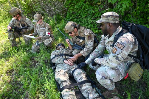 Staff Sgt. Christopher Gangeme, center, 136th Contingency Response Flight security forces team leader, Staff Sgt. Virgil Salidavar, center right, 433rd CRF specialist, and Staff Sgt. Kaden Ables, left, 433rd CRF specialist, trained alongside Senior Airman Erica Nolting, 72nd Operational Medical Readiness Squadron medical technician and Senior Airman Isaac Williams, 72nd Healthcare Operations Squadron medical technician at the Contingency Location Operations Rehearsal (CLOR 24) in Alpena, Michigan June 26, 2024.