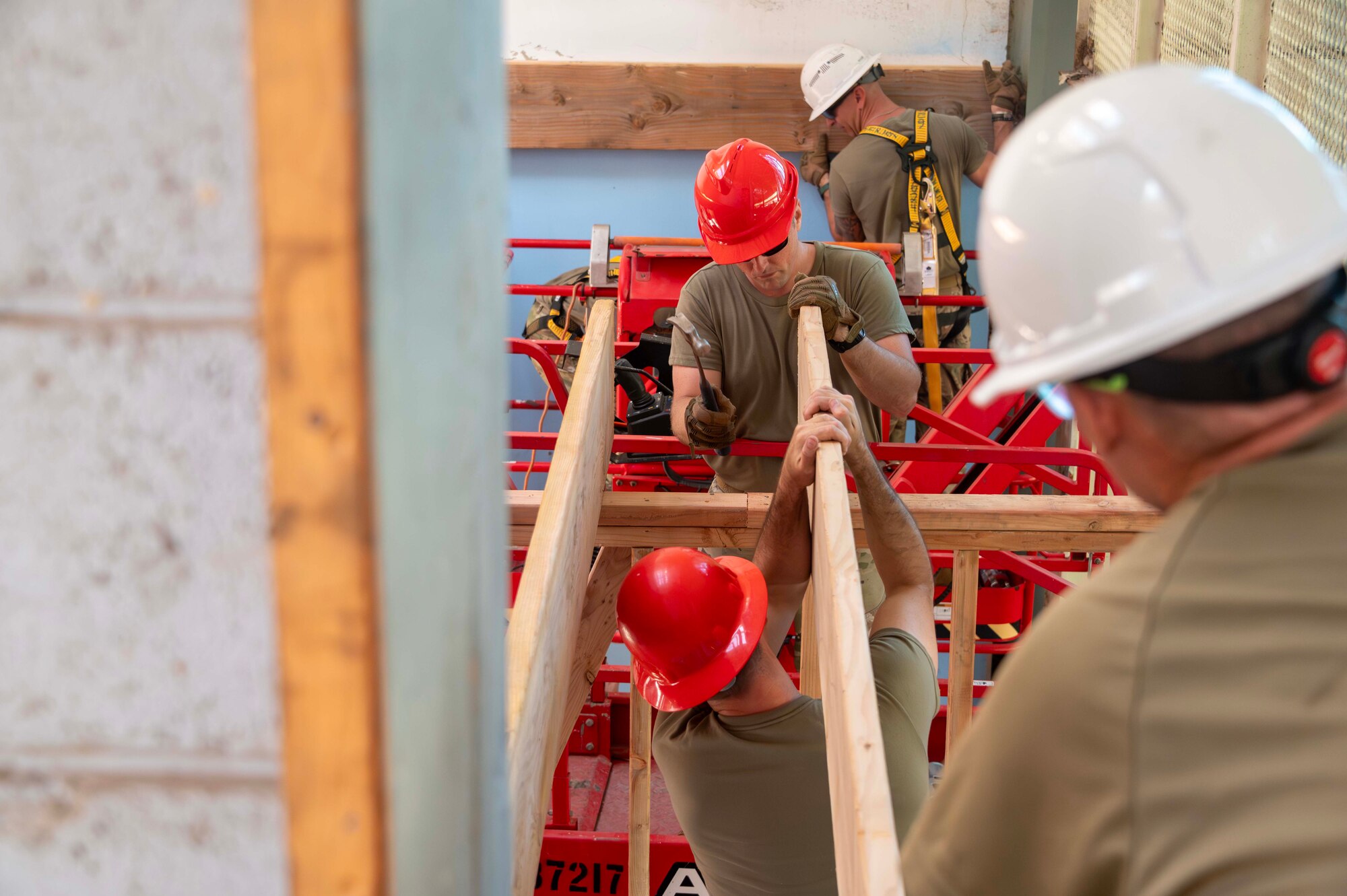 Airmen install a floor joist at Hangar 79 of the Pacific Aviation Museum