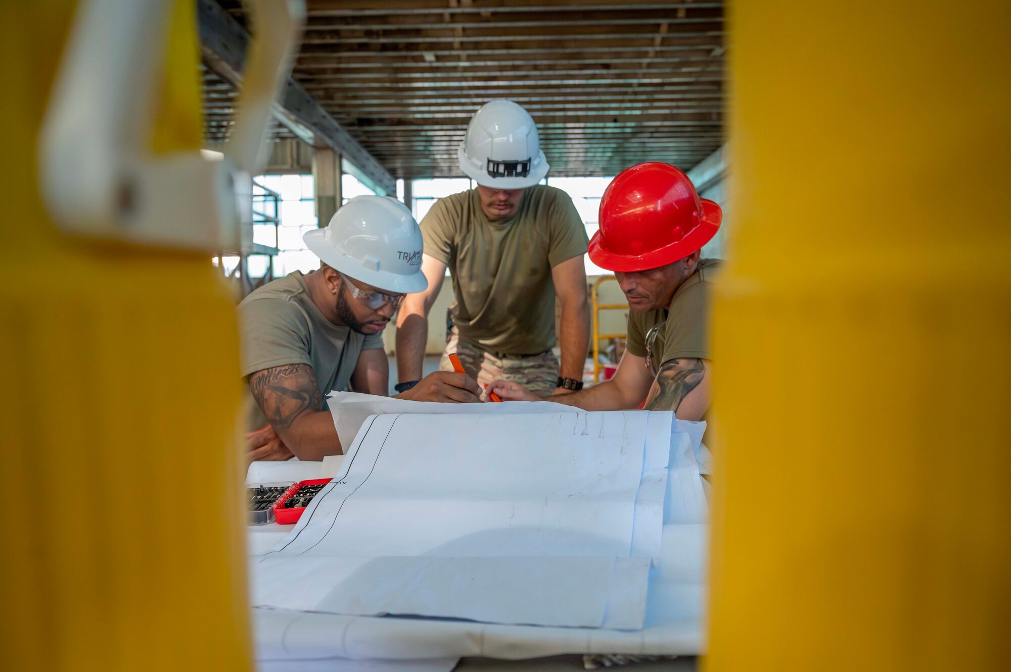Airmen review construction plans at Hangar 29