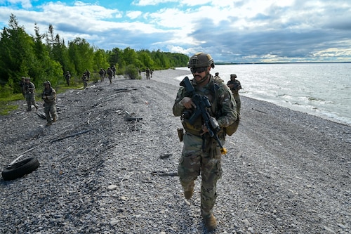 A 433rd Contingency Response Team lead by Technical Sgt. Jerome Williams, 433rd Contingency Response Flight team chief, conduct a beach assault training scenario during the Contingency Location Operations Rehearsal (CLOR 24) at the Combat Readiness Training Center in Alpena, Michigan June 27, 2024.