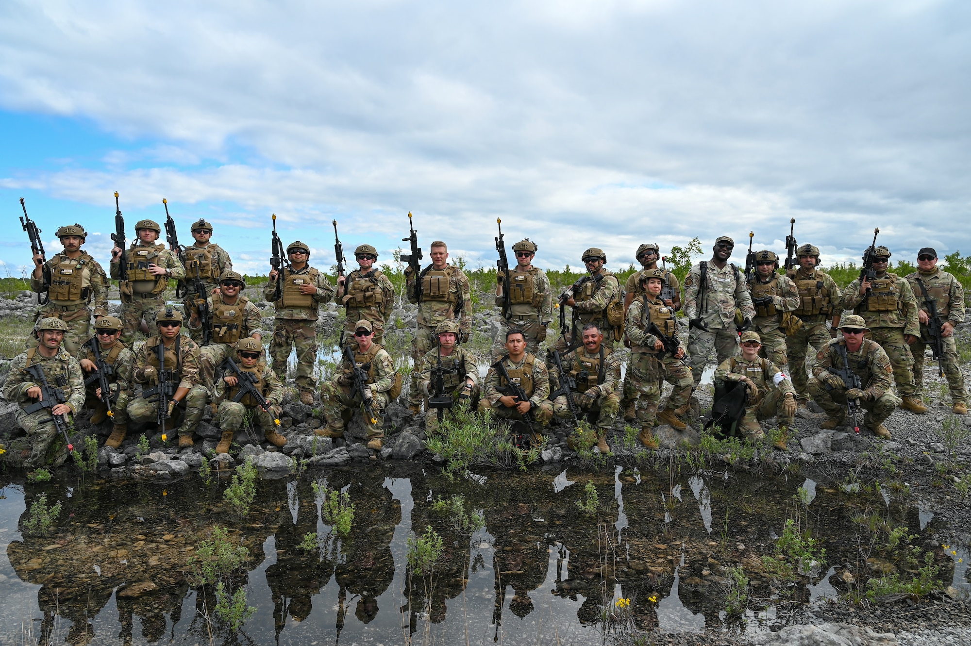 The 433rd Contingency Response Team, performed at the Contingency Location Operations Rehearsal (CLOR 24) at the Combat Readiness Training Center in Alpena, Michigan June 27, 2024, and posed for a group photo at a military training area near Lake Huron.
