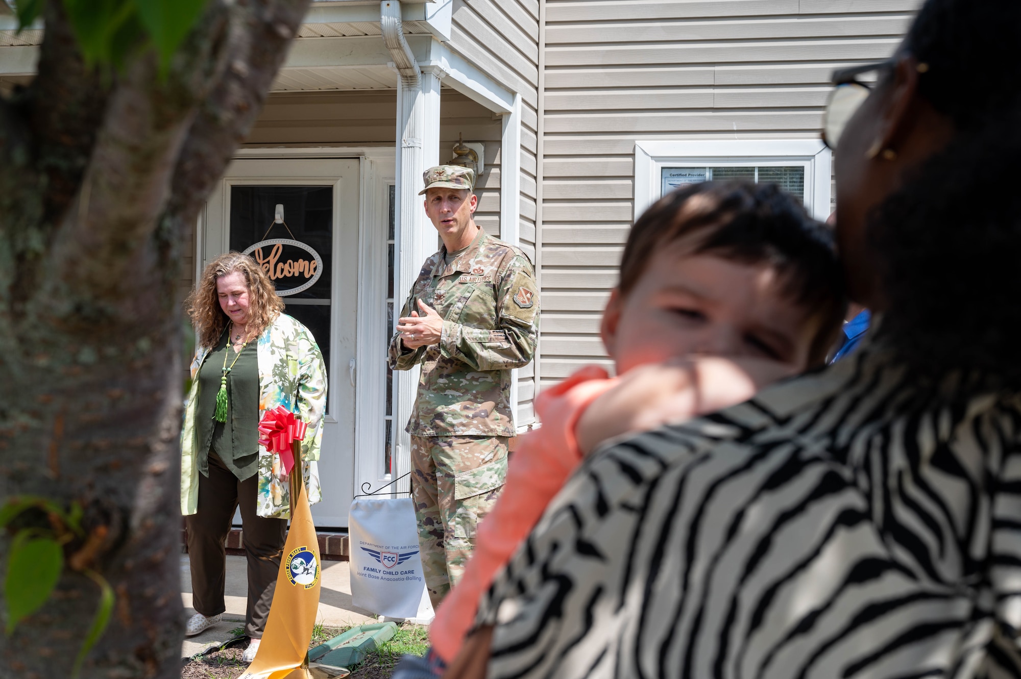 U.S. Air Force Col. Ryan A. F. Crowley, commander of Joint Base Anacostia-Bolling and the 11th Wing, addresses a crowd following the opening of the newest Family Child Care home at JBAB, Washington, D.C., July 10, 2024. Crowley underscored the importance of quality child care for the JBAB community and that this home is a vital addition to support the community. (U.S. Air Force photo by Hayden Hallman)