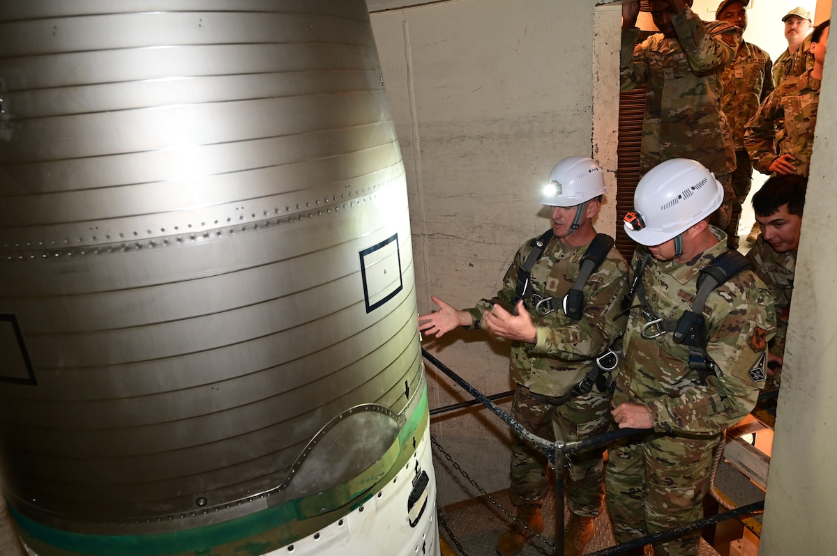 Chief Master Sgt. of the Air Force David Flosi points out aspects of an ICBM to Chief Master Sgt. Edwin Ludwigsen, command chief for Air Force Personnel Command, during a visit to the Alfa-06 launch facility near Pine Bluffs, Wyoming, July 2, 2024. Flosi visited the 90th Missile Wing at F.E. Warren Air Force Base, Wyoming, and the missile field to witness how Airmen continue to provide 24/7 strategic deterrence, standing ready to respond at a moment’s notice in support of the most responsive leg of the nuclear triad. (U.S. Air Force photo by Glenn S. Robertson)