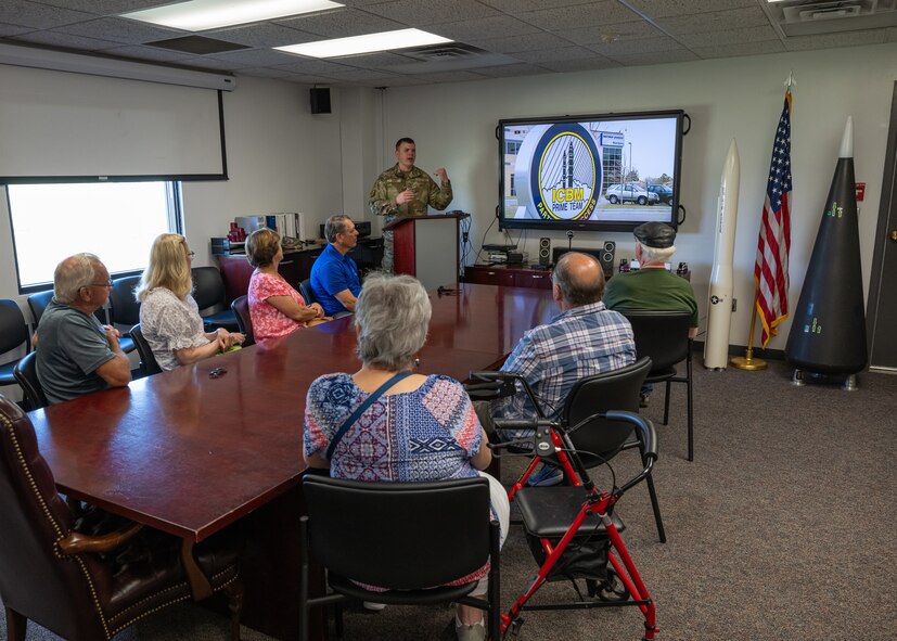 U.S. Air Force Master Sgt. Garrett Jones, 373rd Training Squadron senior enlisted leader, gives a briefing to military retirees during Retiree Appreciation Day at Minot Air Force Base, North Dakota, July 12, 2024. The briefing provided information to the retirees about how the 91st Missile Wing has continued to modernize its capabilities over time. (U.S. Air Force photo by Senior Airman Kyle Wilson)