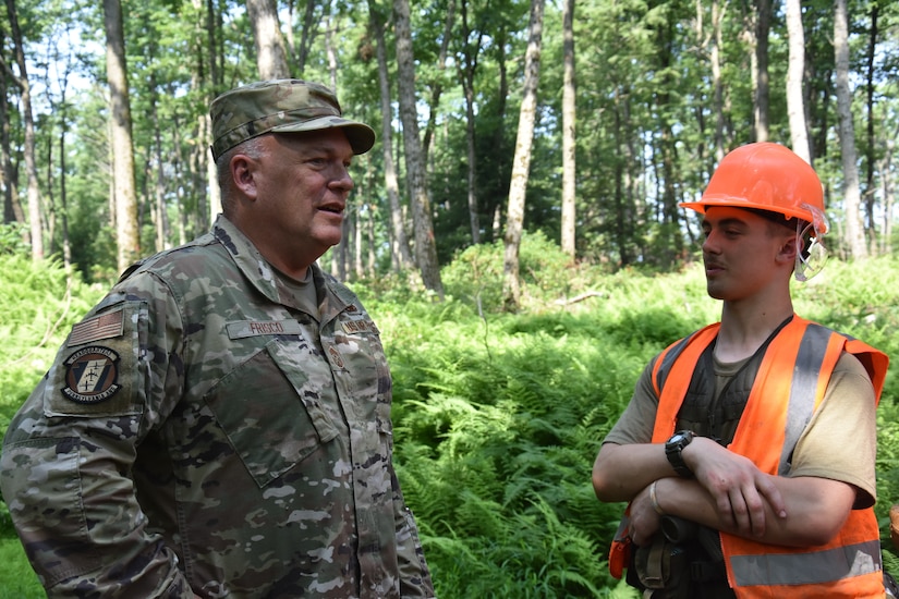 Pennsylvania Air National Guard state command chief, Chief Master Sgt. Paul Frisco, speaks with a cadet about the most challenging and rewarding parts of the weeklong field exercise at Civil Air Patrol’s Hawk Mountain Ranger School in Kempton, Pa., on July 16, 2021. (Photo by Maj. Nicole Reigelman)
