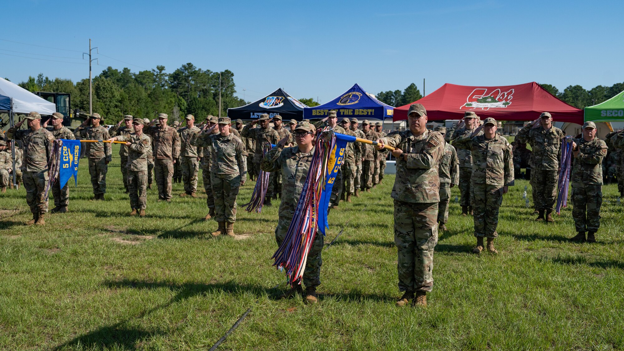 A group of military personnel stand in formation