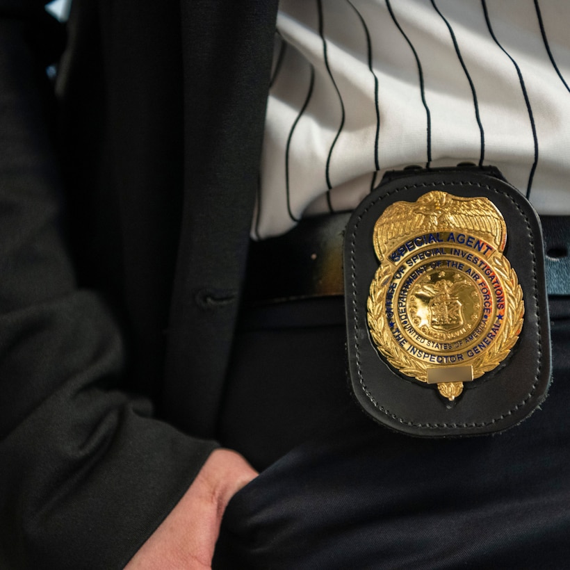OSI Special Agent from Detachment 303 displays their badge at Travis Air Force Base, California, Feb. 10, 2023. (U.S. Air Force photo by Nicolas Pilch)