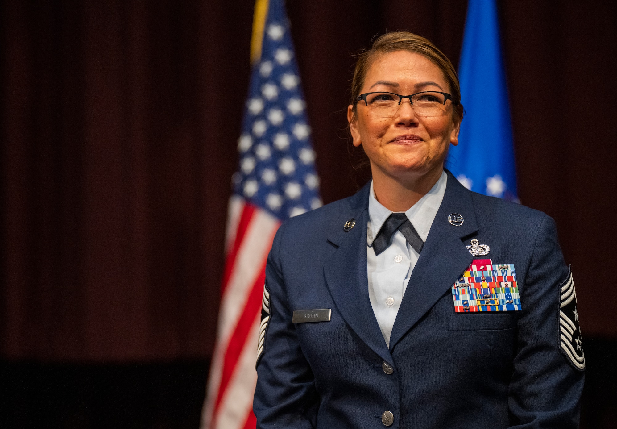 Chief Master Sgt. Bridget Bruhn receives applause after becoming the Thomas N. Barnes Center for Enlisted Education command chief during a change of responsibility ceremony on Maxwell Air Force Base, Gunter Annex, Alabama, July 12, 2024. (U.S. Air Force photo/Brian Ferguson)