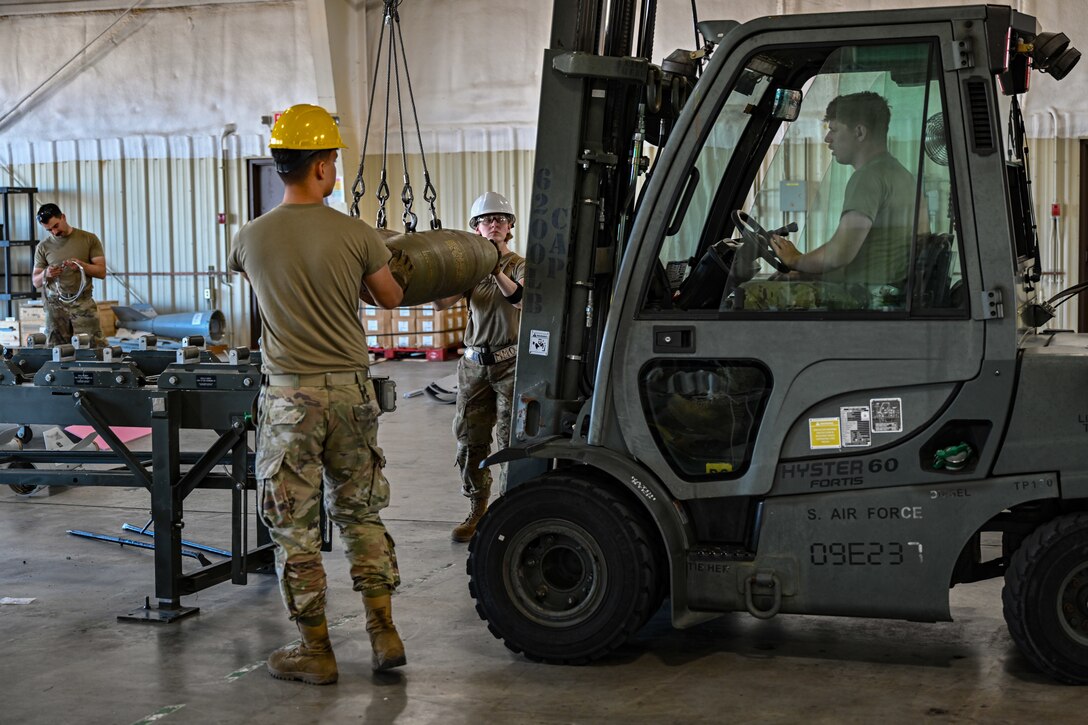 U.S. Air Force Airmen from the 28th Munitions Squadron transport MK-82 bomb bodies during a Combat Ammunition Production Exercise at Ellsworth Air Force Base, S.D., July 9, 2024. The exercise focused on building Guided Bomb Units (GBUs) and other munitions en masse, highlighting the critical role of munitions specialists in producing sustained combat air power in any scenario. (U.S. Air Force photo by Staff Sgt. Jake Jacobsen)