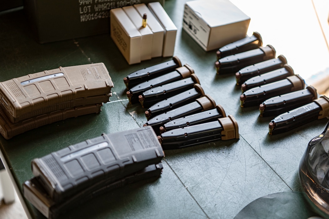 U.S. Air Force M4 carbine and M18 pistol magazines rest on a table at Moody Air Force Base, Georgia, July 12, 2024. U.S. Air Force Col. Paul Sheets, 23rd Wing commander, visited the 820th Base Defense Group and was able to immerse himself into the mission and shoot multiple weapon systems. Battlefield circulations allow the base senior leaders to visit different units to learn about the work the Airmen do and get a true picture of how they operate in their day-to-day duties. (U.S. Air Force photo by Airman 1st Class Leonid Soubbotine)