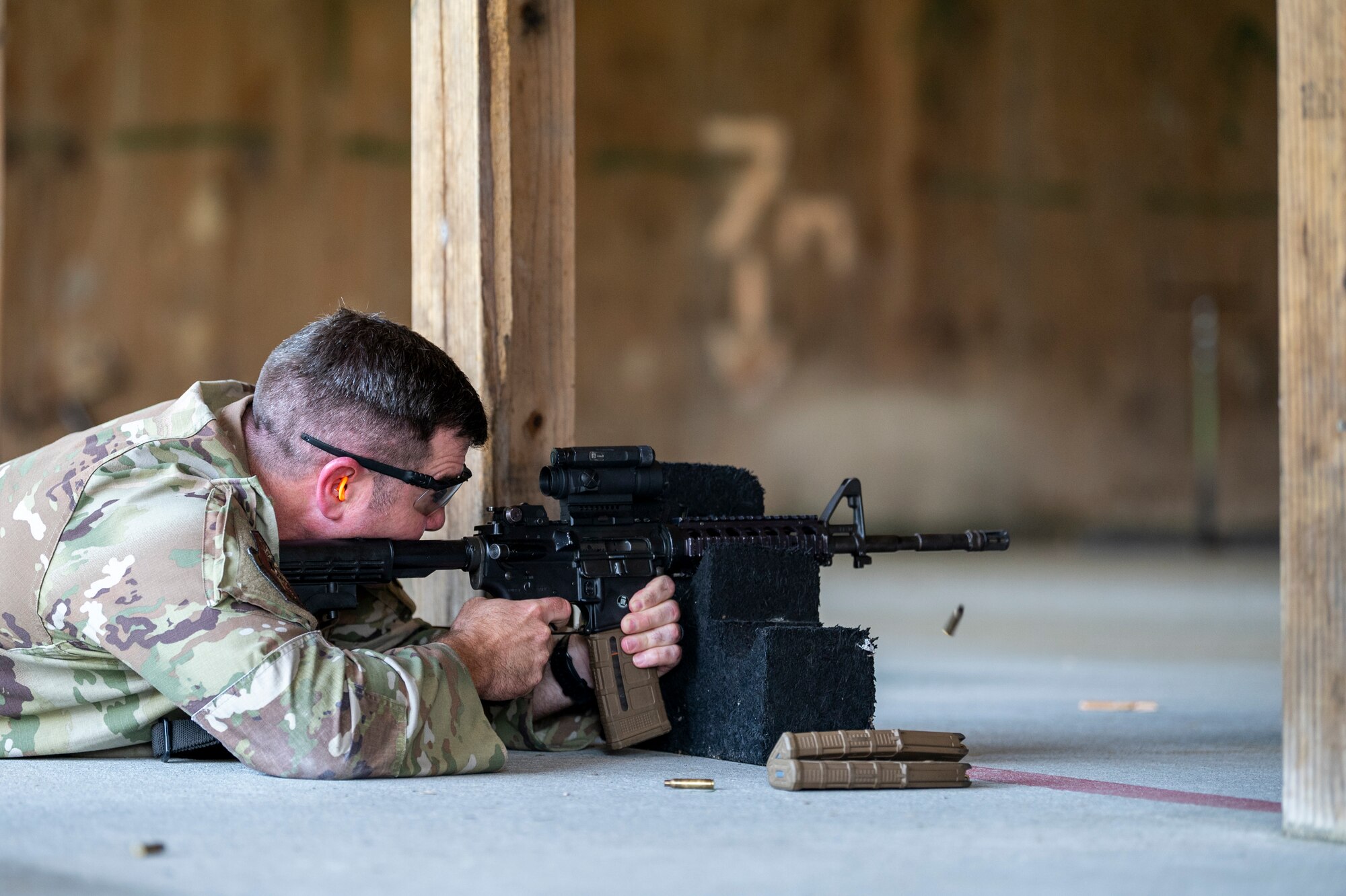 U.S. Air Force Col. Paul Sheets, 23rd Wing commander, fires an M4 carbine at Moody Air Force Base, Georgia, July 12, 2024. Sheets was able to fire an M4 carbine, M18 pistol and M870 shotgun during his battlefield circulation (BFC) at the 820th Base Defense Group. BFCs allow the base senior leaders to visit different units to learn about the work the Airmen do and get a true picture of how they operate in their day-to-day duties. (U.S. Air Force photo by Airman 1st Class Leonid Soubbotine)