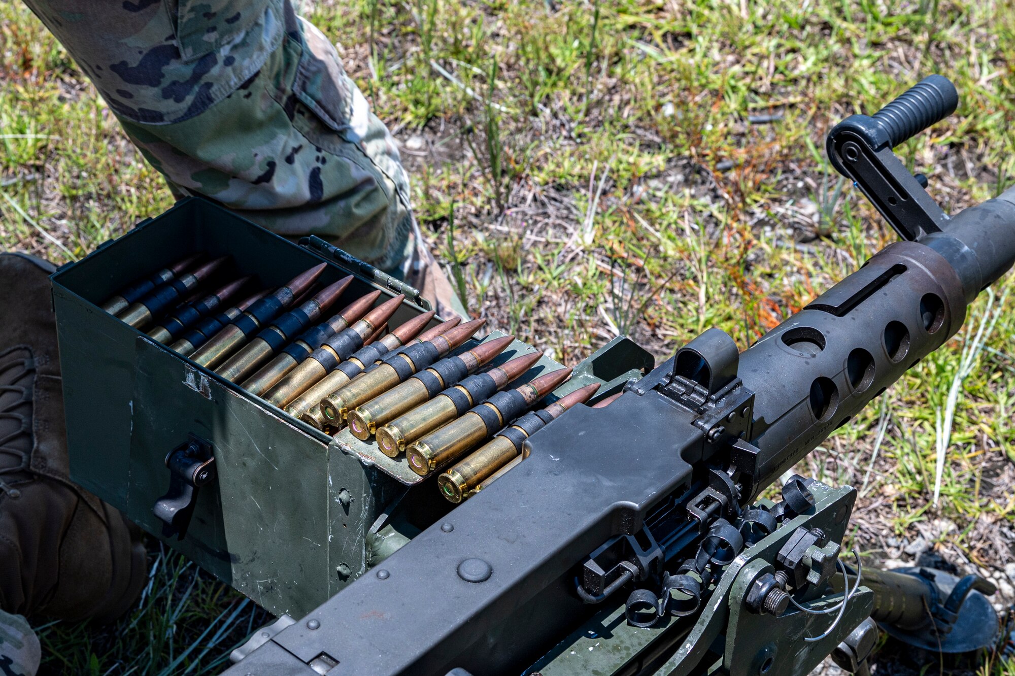 An U.S. Air Force Airman assigned to the 820th Combat Operations Squadron, loads an M2A1 machine gun at Moody Air Force Base, Georgia, July 12, 2024. 23rd Wing Base leadership were able to fire the machine gun and the M110A1 squad designated marksman rifle at the outdoor range during the battlefield circulation (BFC). BFCs allow the base senior leaders to visit different units to learn about the work the Airmen do and get a true picture of how they operate in their day-to-day duties. (U.S. Air Force photo by Airman 1st Class Leonid Soubbotine)