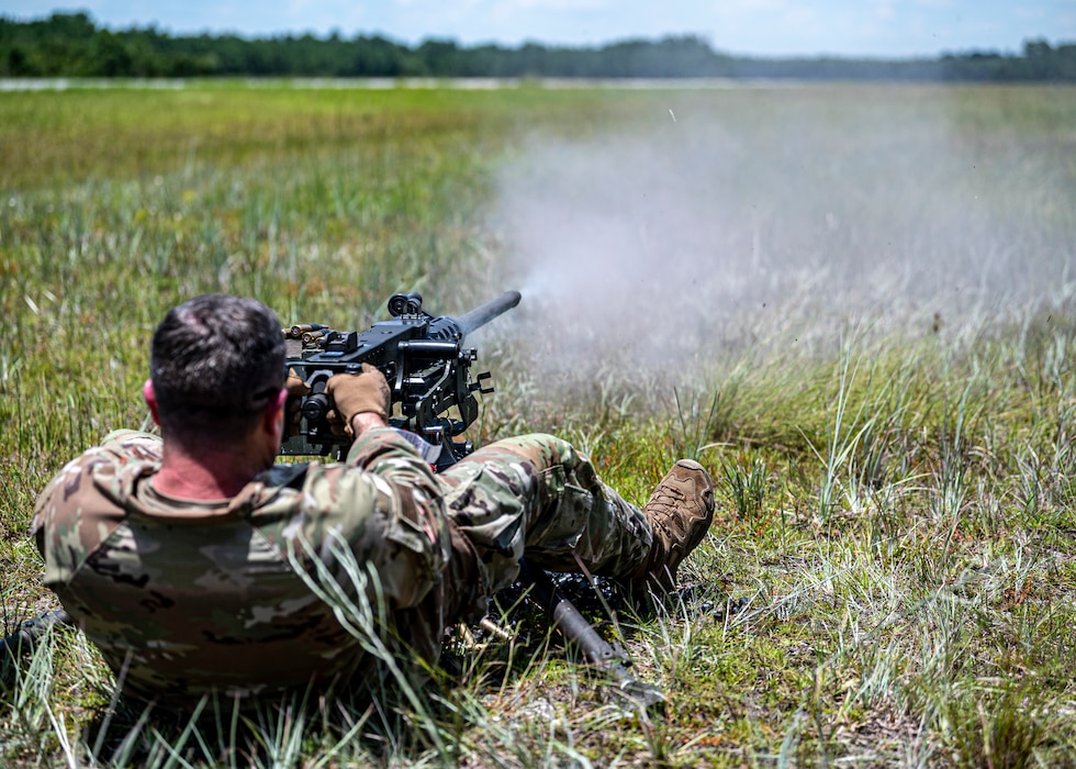 U.S. Air Force Col. Paul Sheets, 23rd Wing commander, fires an M2A1 machine gun at Moody Air Force Base, Georgia, July 12, 2024. Airmen from the 820th Combat Operations Squadron demonstrated the correct technique for operating the belt-fed machine gun to Sheets during the battlefield circulation (BFC). BFCs allow the base senior leaders to visit different units to learn about the work the Airmen do and get a true picture of how they operate in their day-to-day duties. (U.S. Air Force photo by Airman 1st Class Leonid Soubbotine)